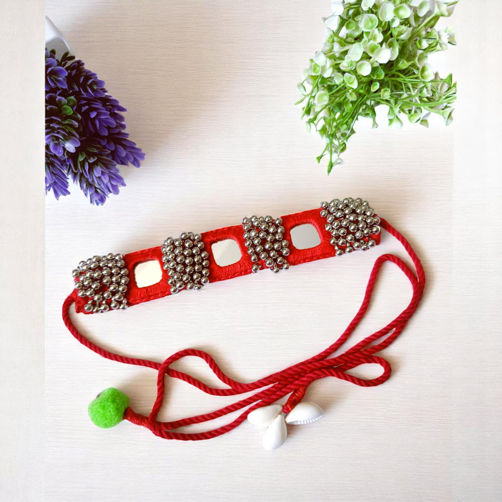 Intricate mirror work catches the light across this beaded choker.