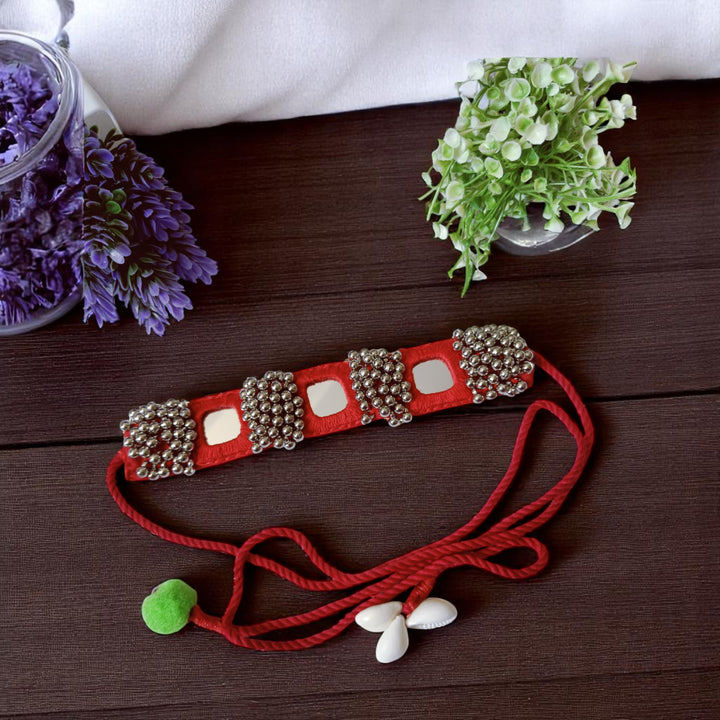 Adjustable handmade tie-up secures this red beaded choker.