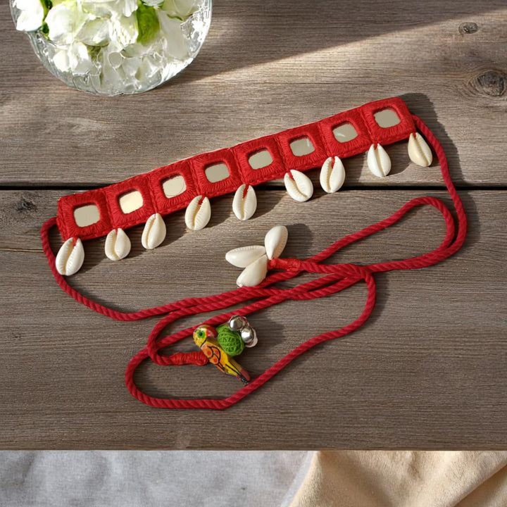 Adjustable thread tie-up secures this red fabric choker.