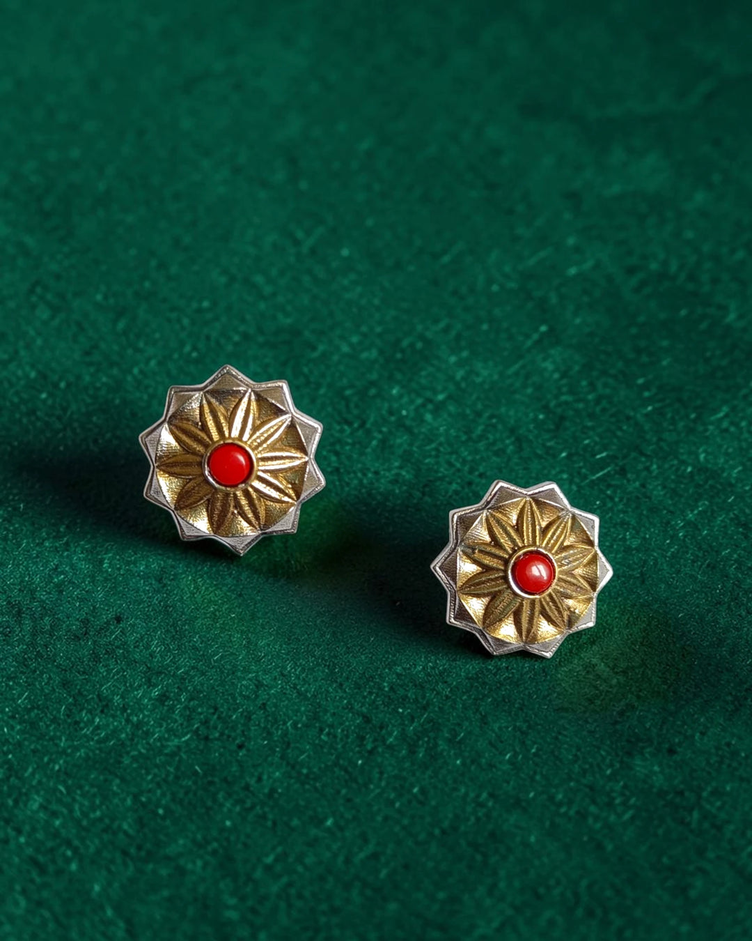 Contemporary geometric flower shape defines this dual-tone red stud.