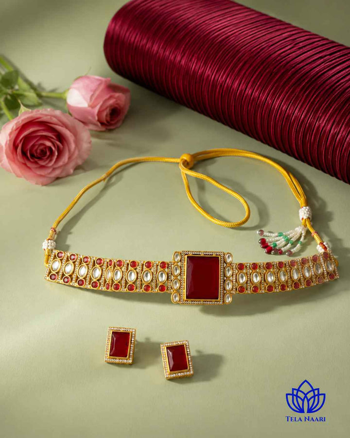 Statement silhouette showcases the bold red stone centrepiece.