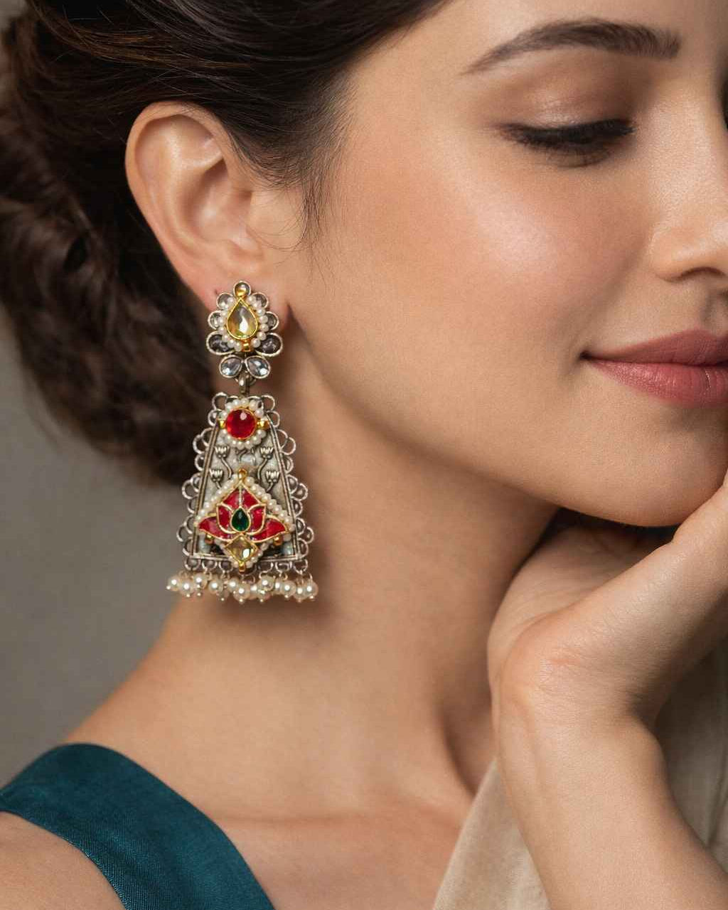 Traditional kundan stone work shapes the silhouette of this earring.