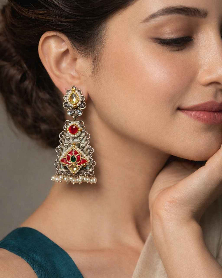 Traditional kundan stone work shapes the silhouette of this earring.