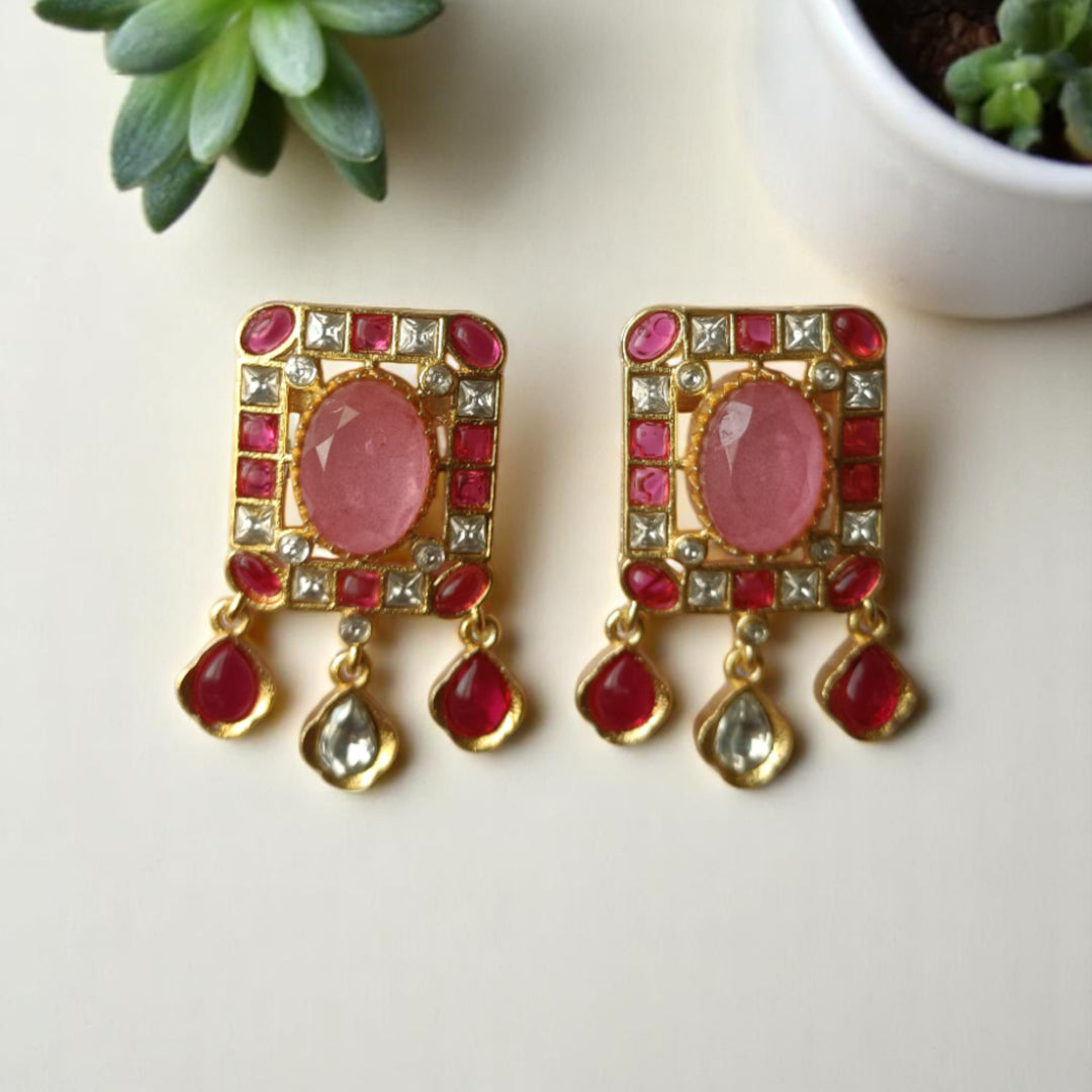 Matching earrings complete this ruby pink kundan necklace set.