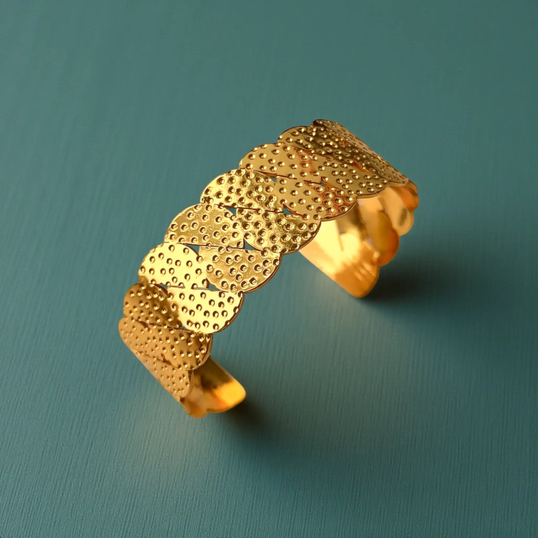 Stainless steel construction supports the scalloped edge of this cuff.