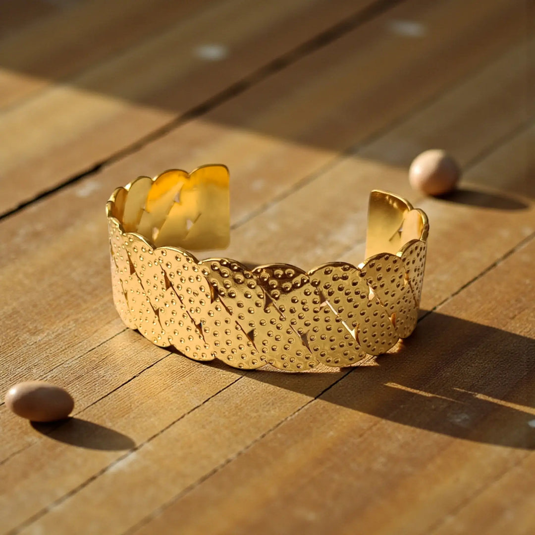 Textured edge defines the scallop pattern along this cuff bracelet.