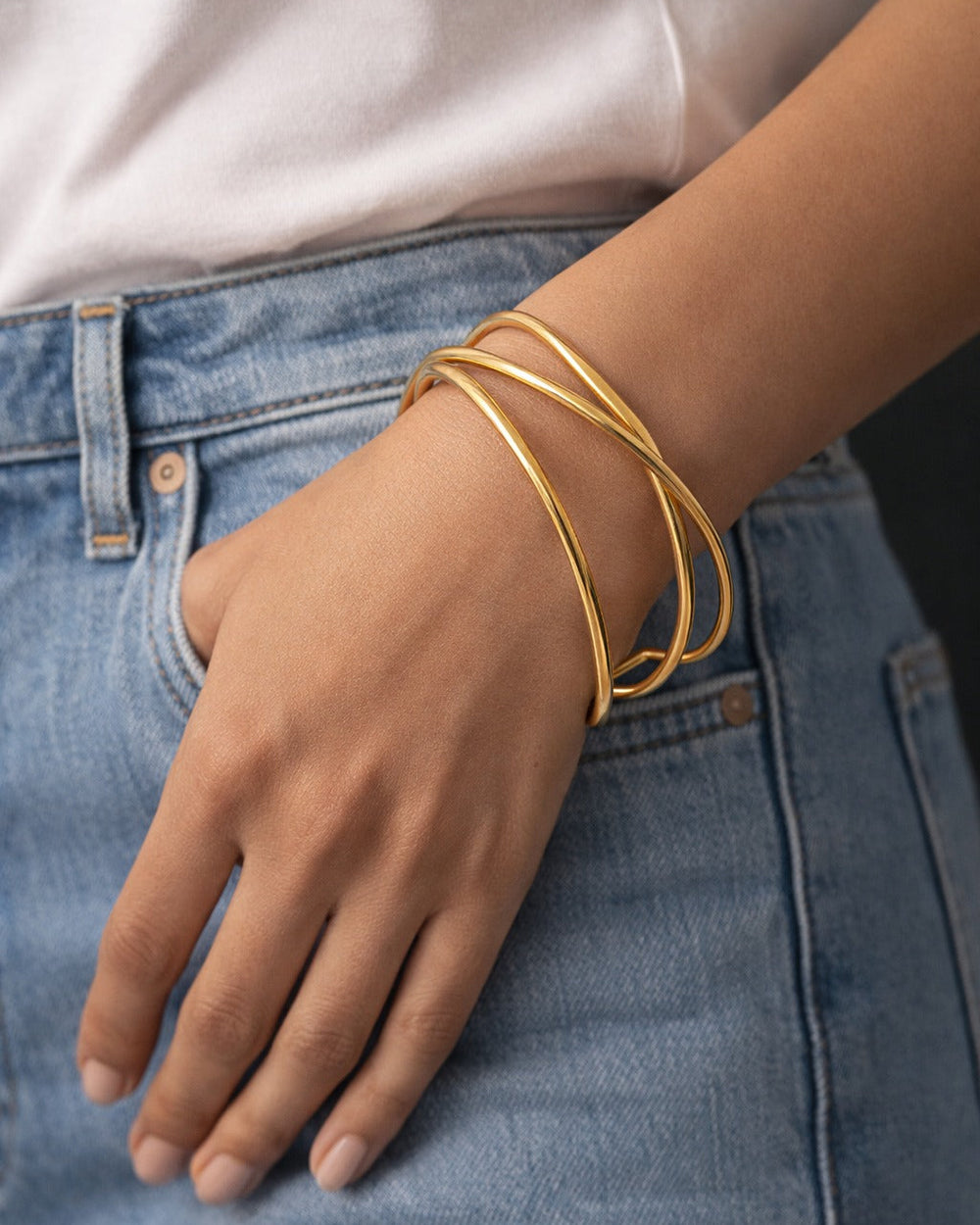 Brass construction supports the polished finish of this open cuff.