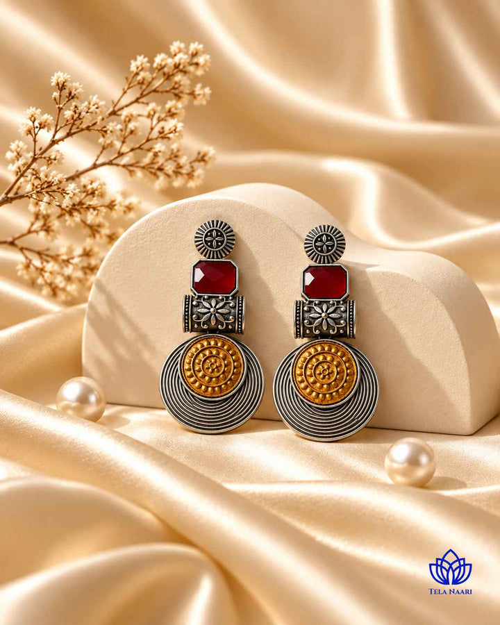 Silver-plated finish covers half of this dual-tone red earring.