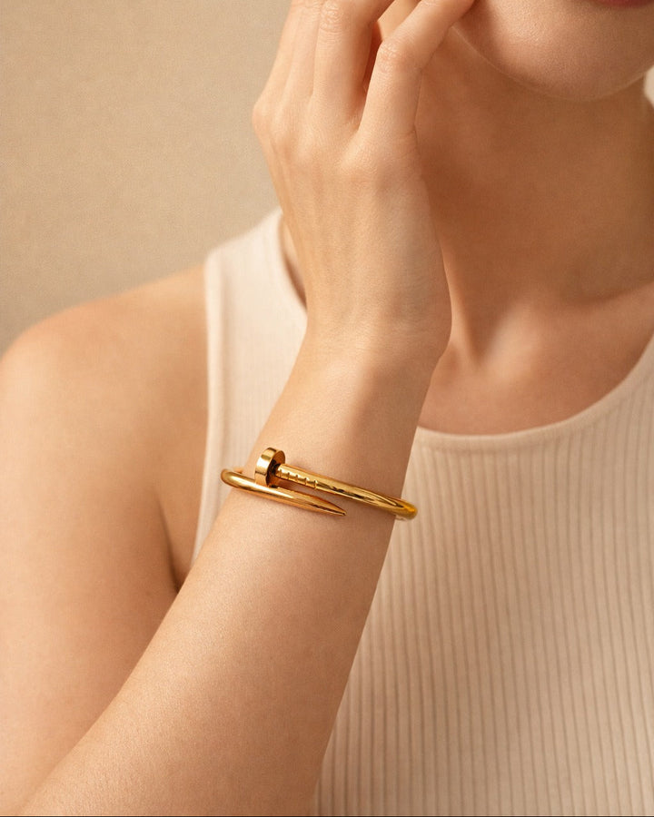 Adjustable open design lets this nail-head cuff fit most wrist sizes.