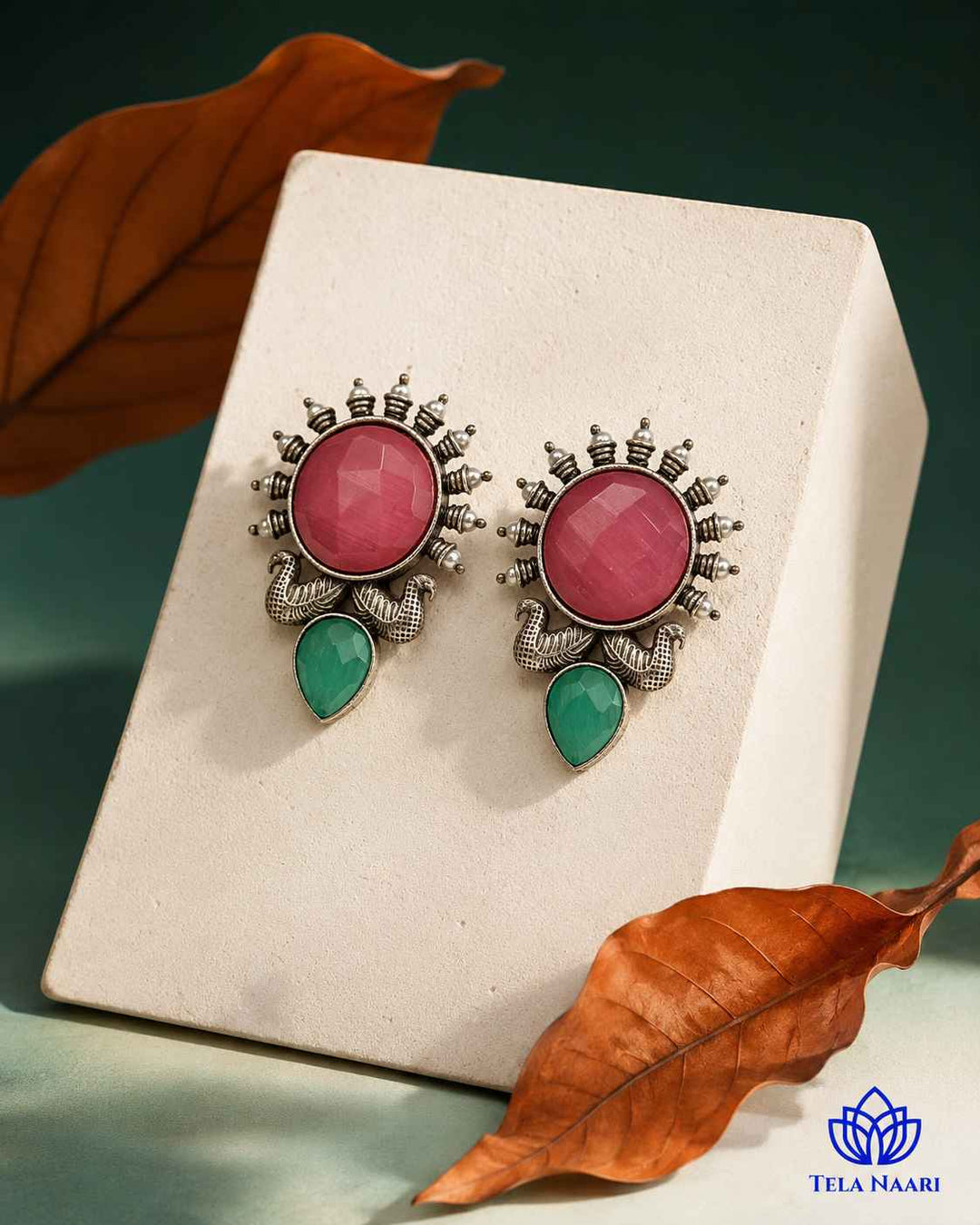Radiant sunburst design forms the centrepiece of this pink earring.