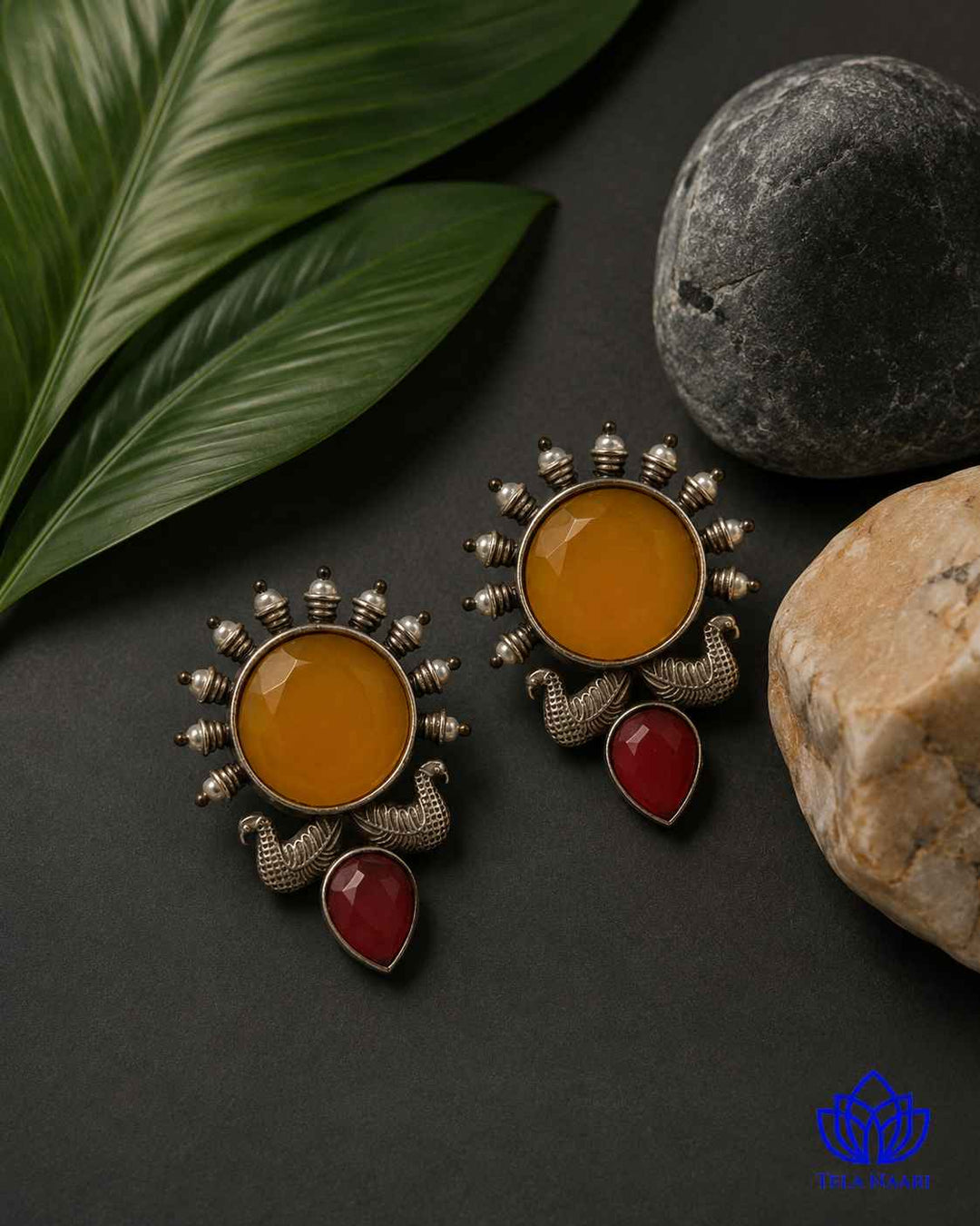 Push-back closure secures this oxidised sunburst earring in place.