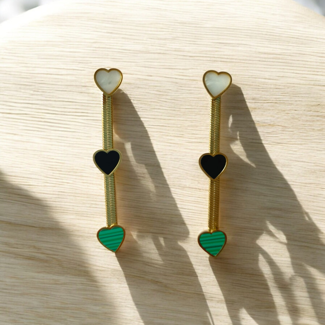“Tela Naari triple heart drop earrings in 18K gold”