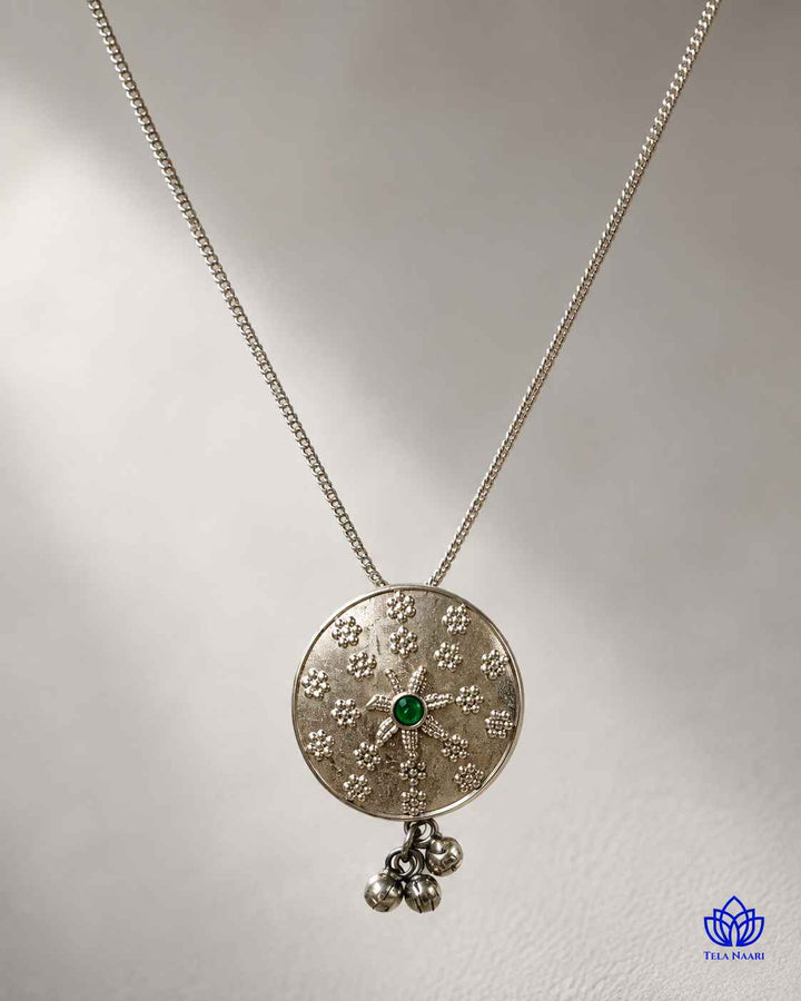 Timeless design pairs a green stone with silver plating.