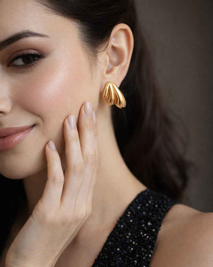 Stackable design lets this leaf stud pair with other earrings.