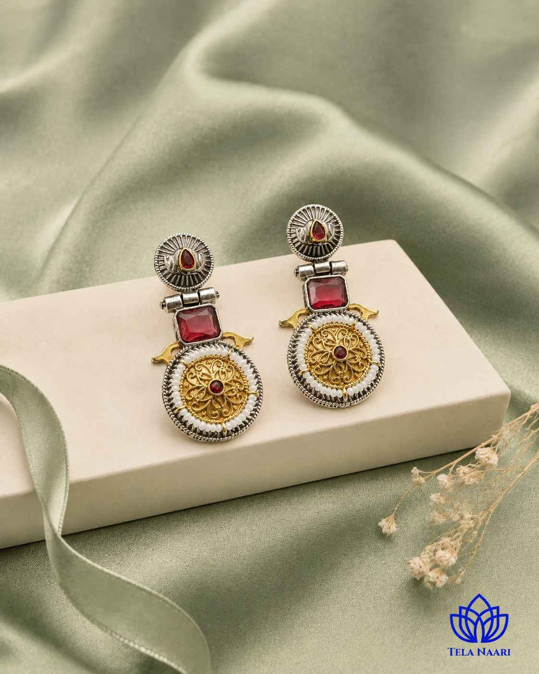 Two-inch length shapes the drop of this red earring.