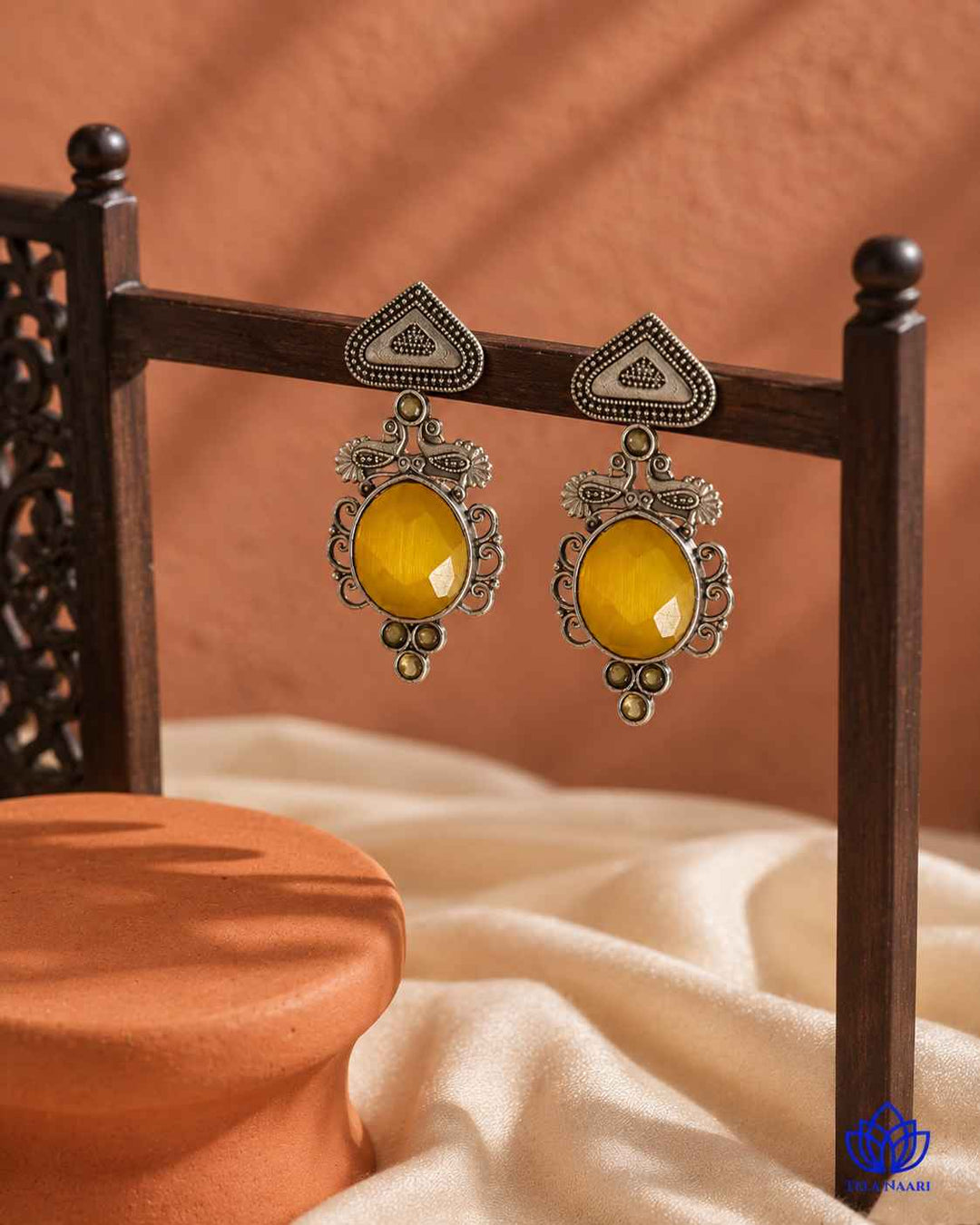 Textured surface reflects light across the oxidised silver finish.