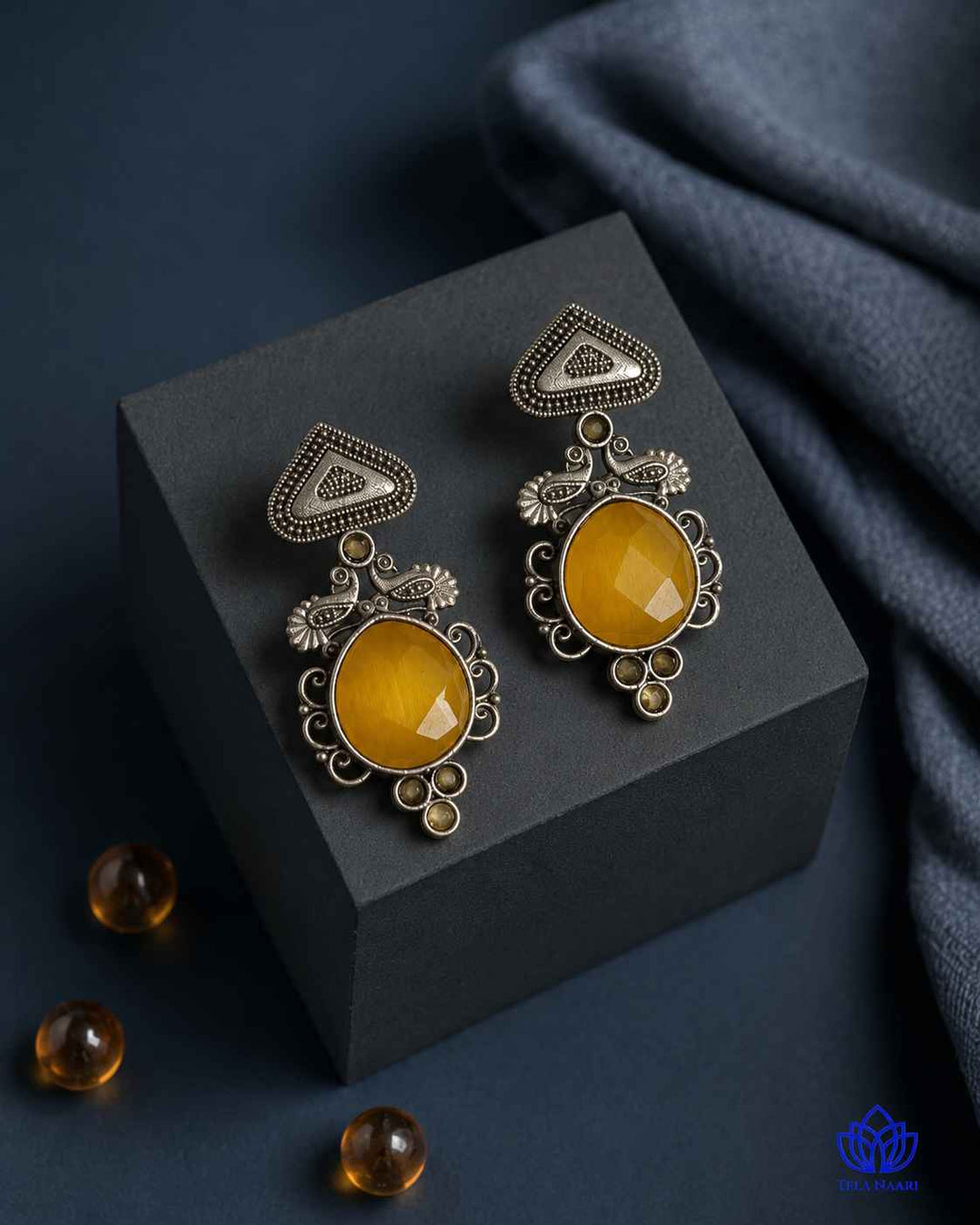 Poised silhouette defines this sleek silver oxidised earring design.