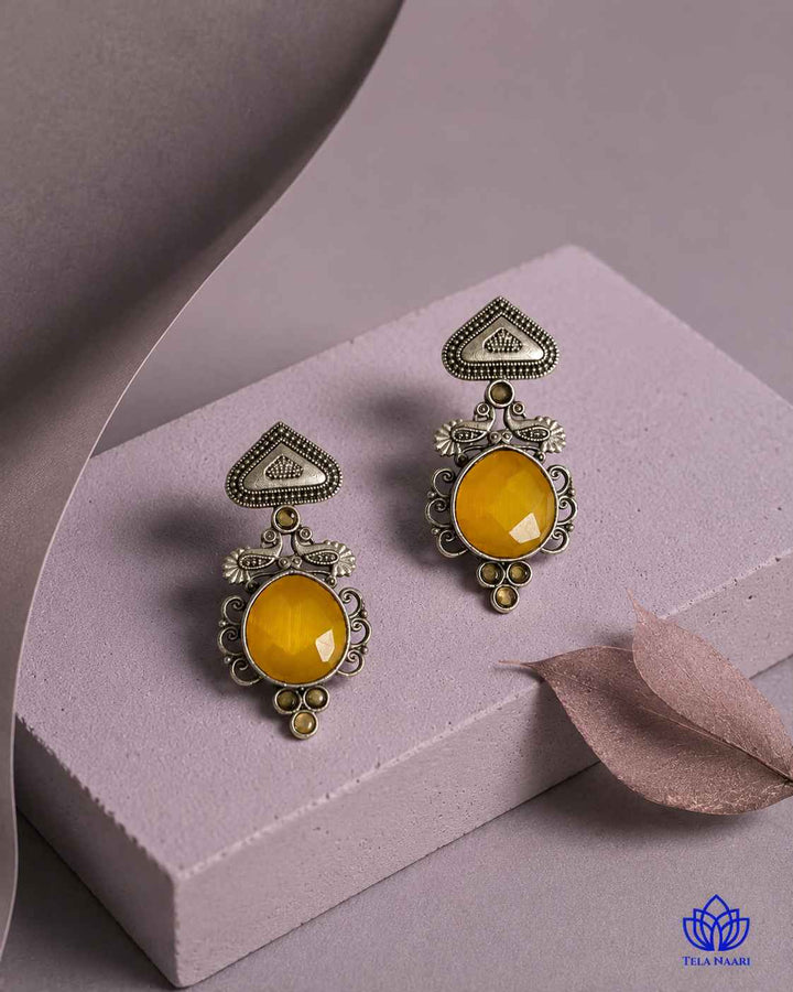 Versatile silhouette pairs yellow tones with oxidised silver plating.