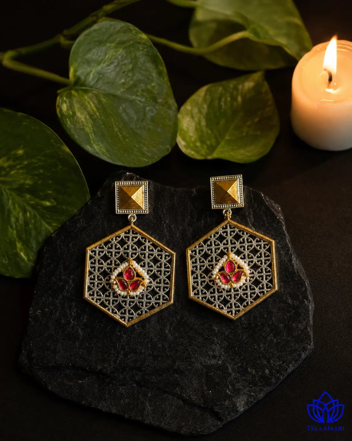 Brass construction supports the oxidised finish of this earring.