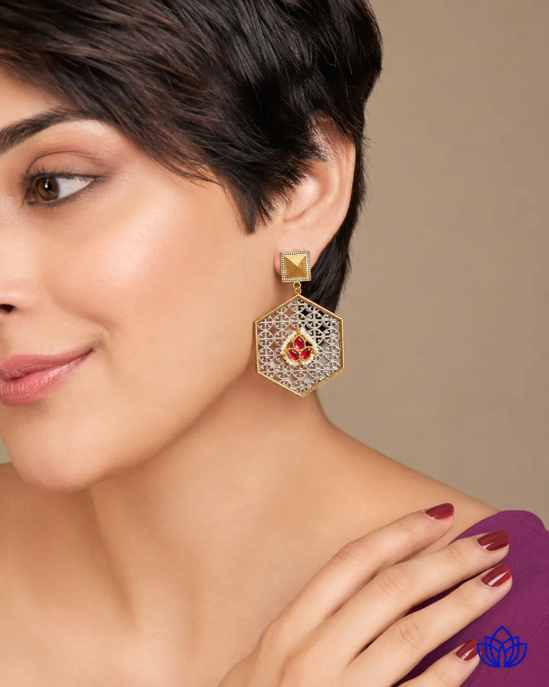Push-back closure secures this dual-tone hexagon earring in place.