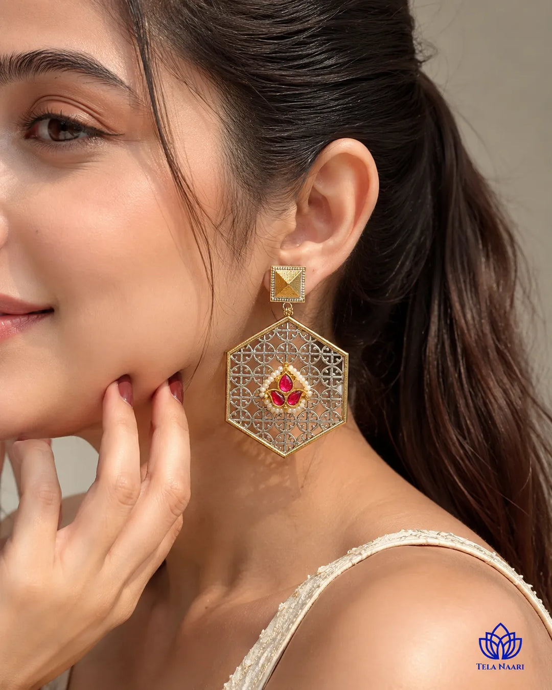 Silver-plated finish covers one half of this dual-tone earring.