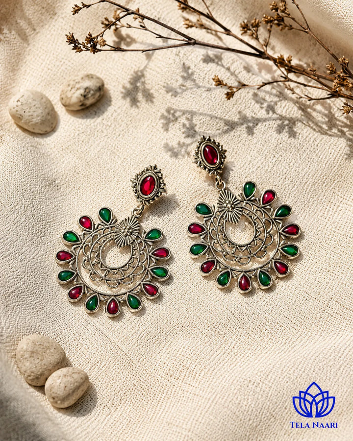 Contemporary edge defines the silhouette of this oxidised drop earring.