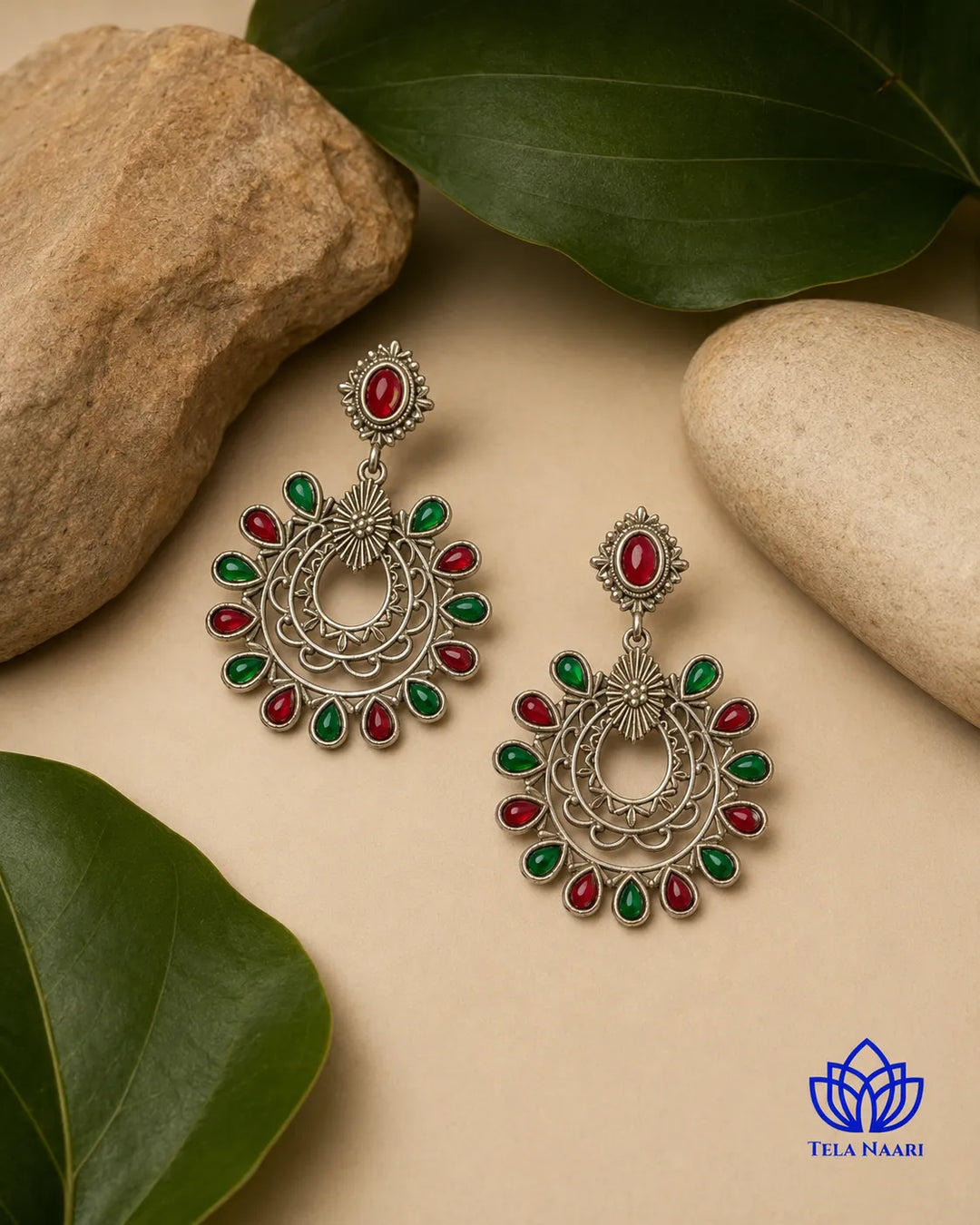 Vibrant red and green gemstones sit at the centre of this earring.