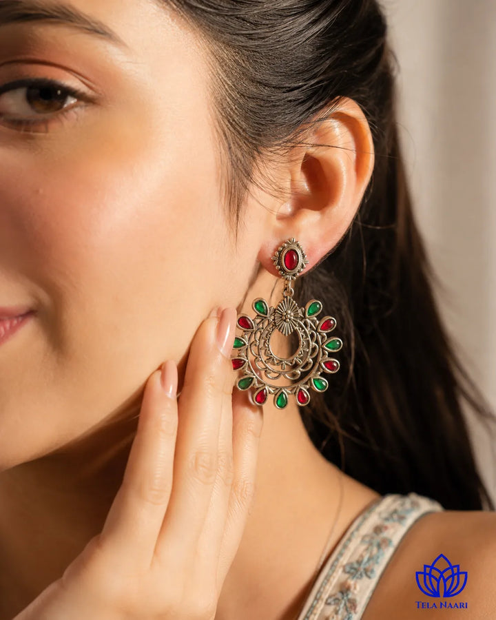 Oxidised silver finish covers the surface of this drop earring.