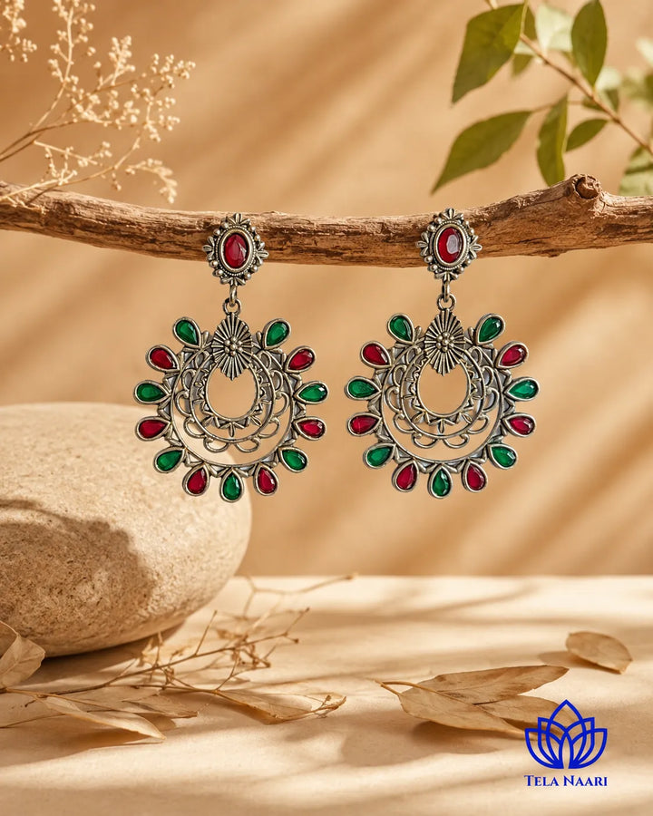 Traditional silhouette meets contemporary colour in this drop earring.