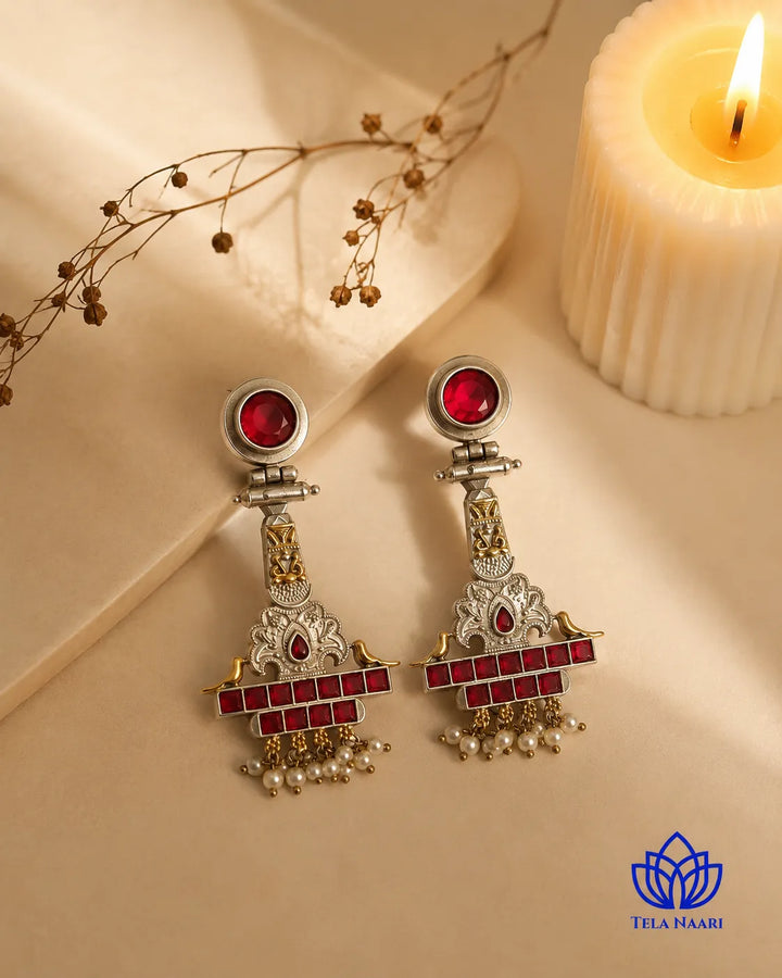 Festive detailing highlights the temple motif of this earring.