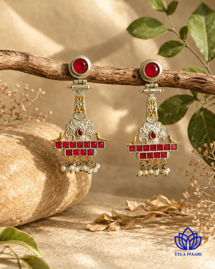 Lustrous ruby and pearl accents shape this dual-tone temple earring.