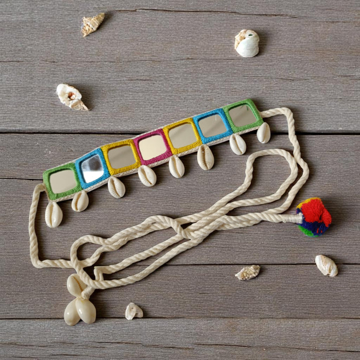 Natural shell details decorate the surface of this fabric choker.