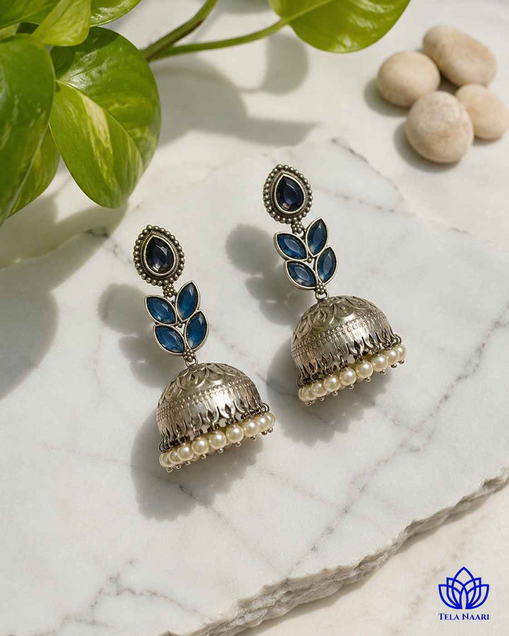 Brass construction forms the base of this teardrop jhumka earring.