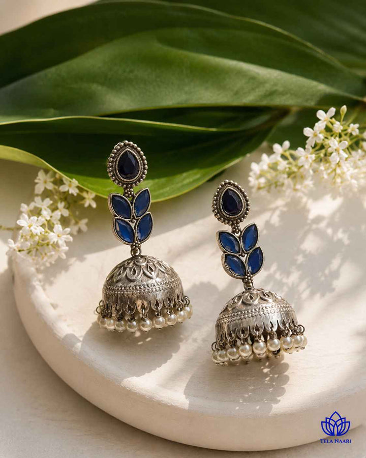 Traditional jhumka shape pairs with a silver-plated blue finish.