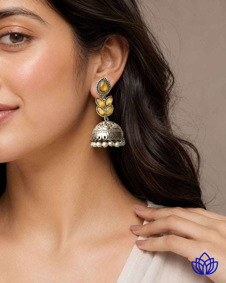 Rounded teardrop shape defines the silhouette of this silver-plated earring.