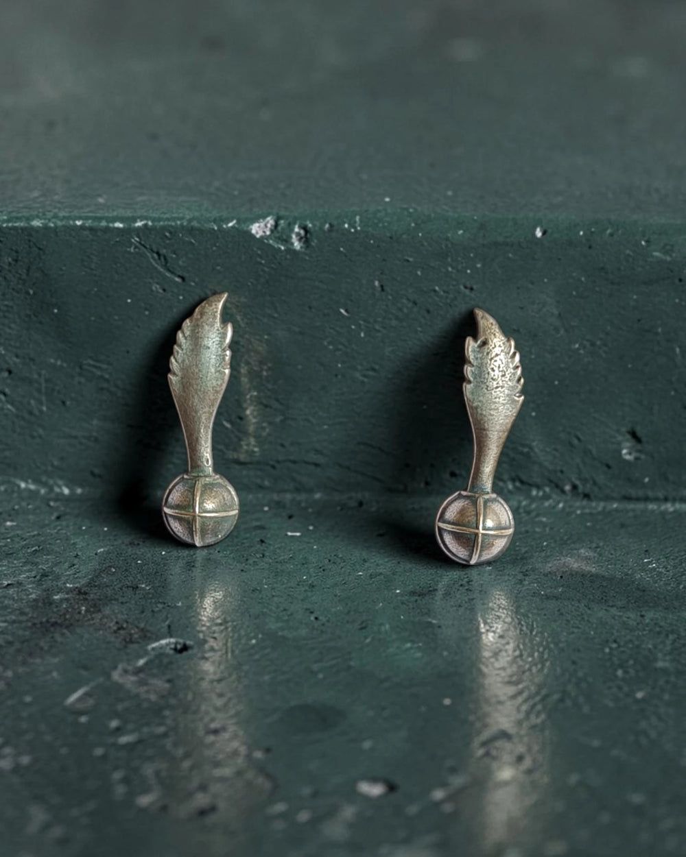 Darkened oxidised finish gives this wing stud its artisanal charm.