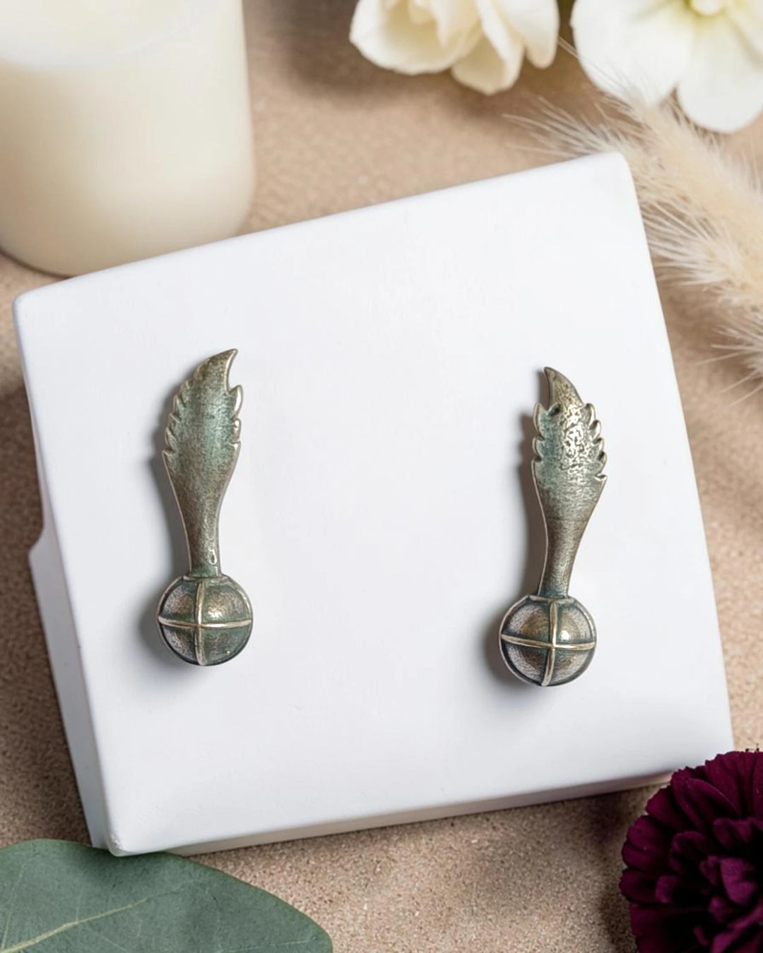 Delicate wing-shaped silhouette defines this oxidised silver stud earring.
