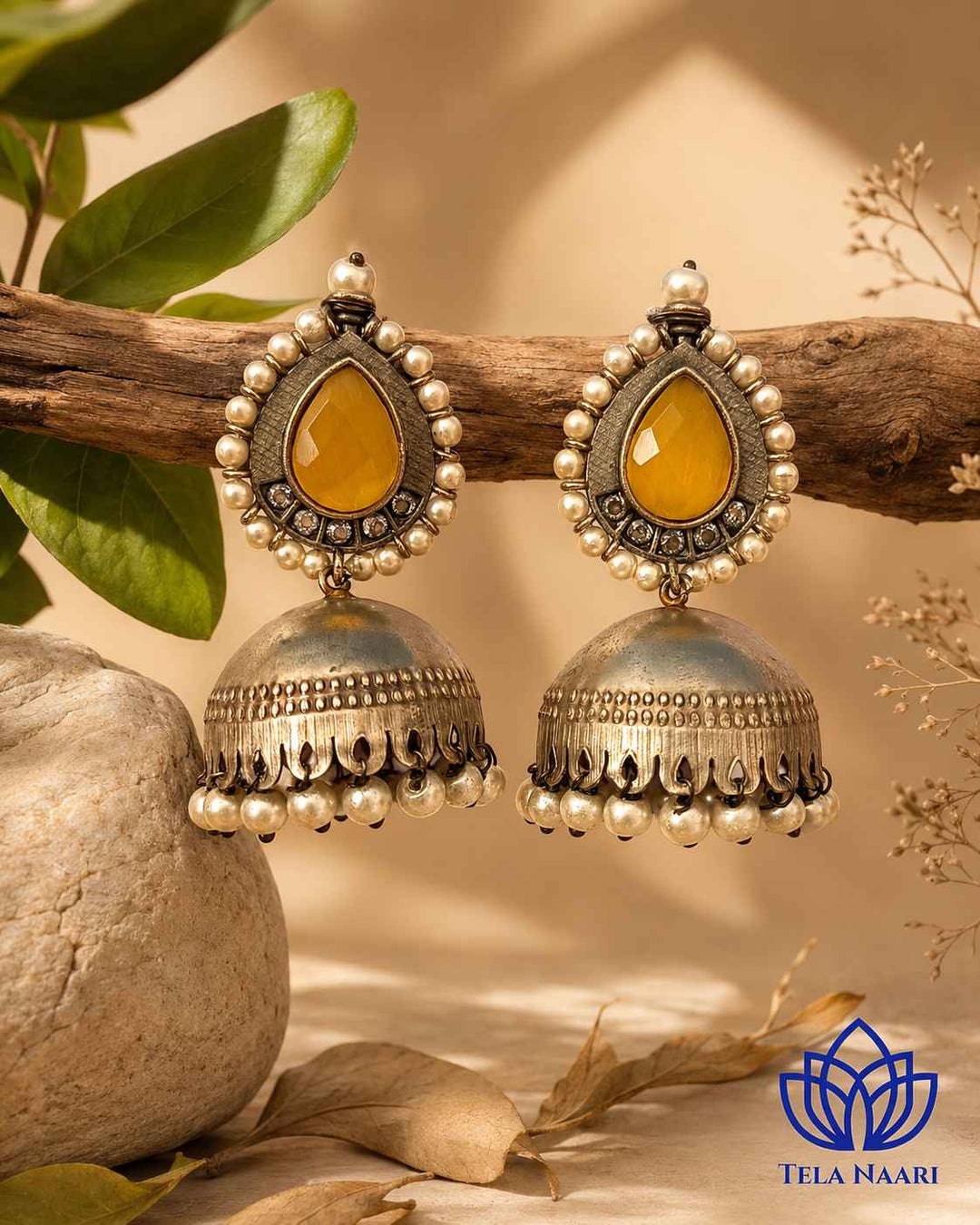 Bead work adds texture and warmth to this yellow jhumka design.