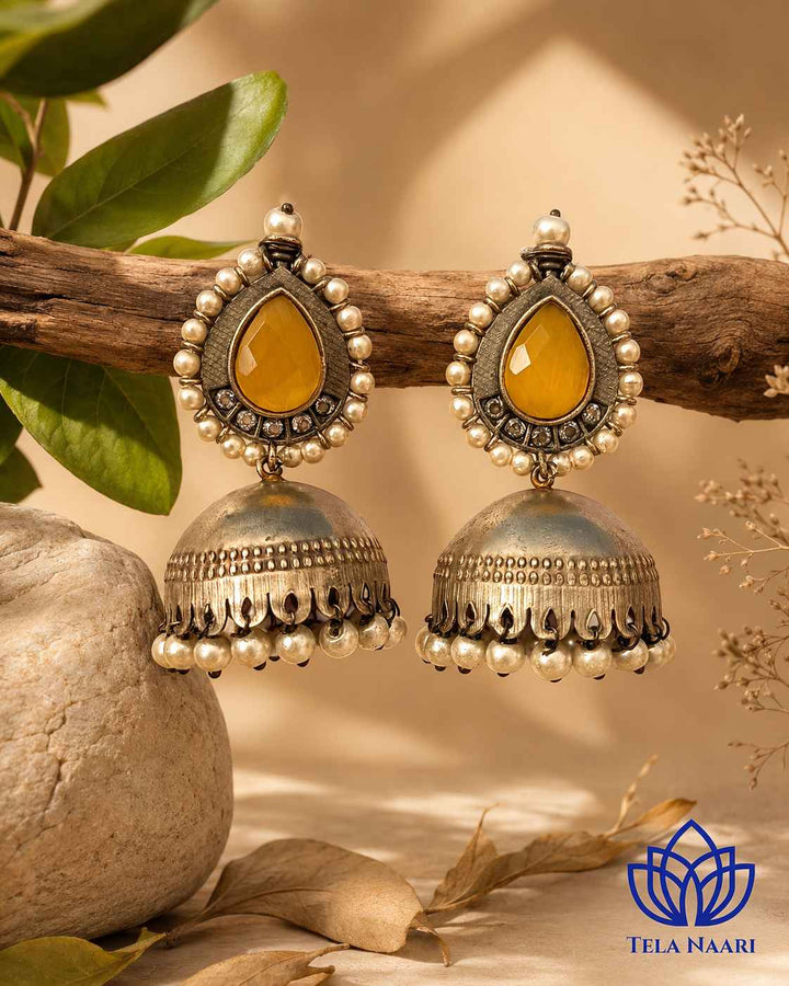 Bead work adds texture and warmth to this yellow jhumka design.