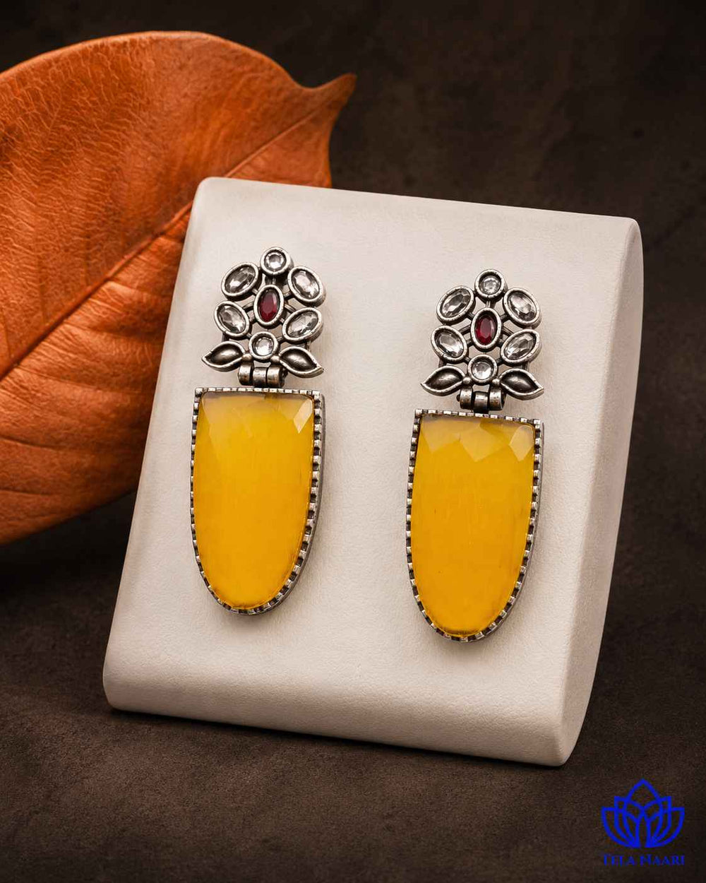 Lustrous silver finish gives this yellow earring its confident edge.