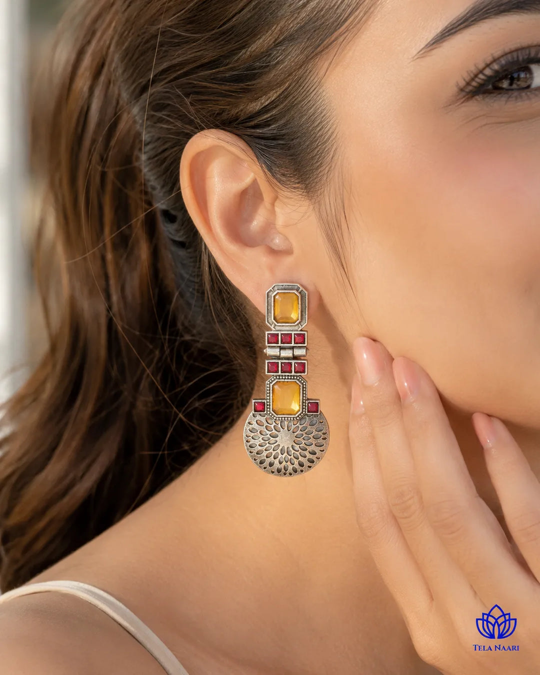 Brass construction forms the structure of this statement earring shape.