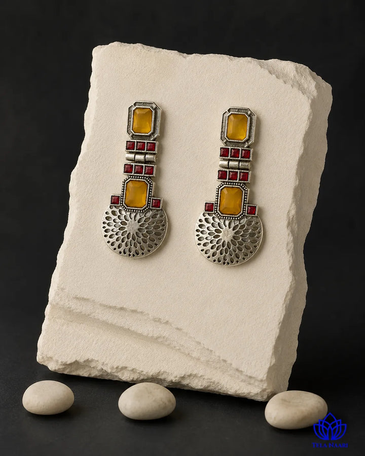 Oxidised silver finish covers the surface of this statement earring.